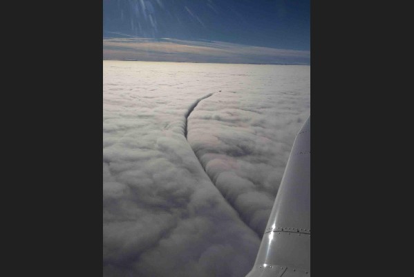 Another Plane Drawing a line in the cloud